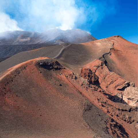 Hike up Mount Etna and admire the volcanic craters, a short drive away