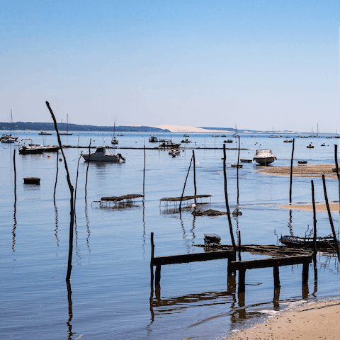 Watch gentle waves lap the shore at Arcachon Beach, a minute's walk from your building