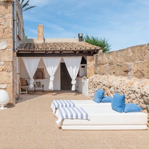 Relax on a daybed in the secluded garden