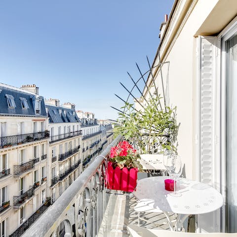 Sip wine on the balcony in the summer sunshine, soaking up the Parisian atmosphere