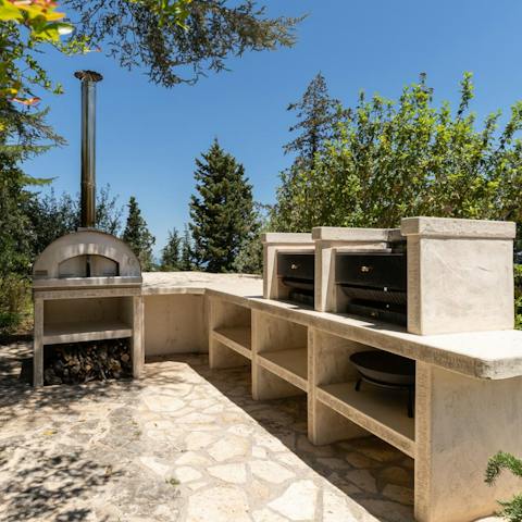 Get cooking under the sun with the pizza oven and double barbecue