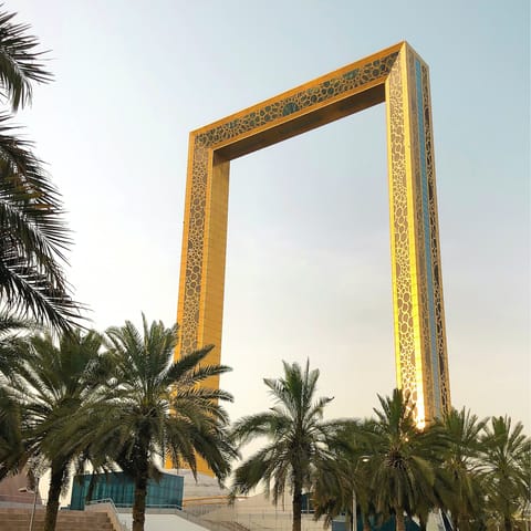 Visit the observation deck of the Dubai Frame and watch the sun set over the city