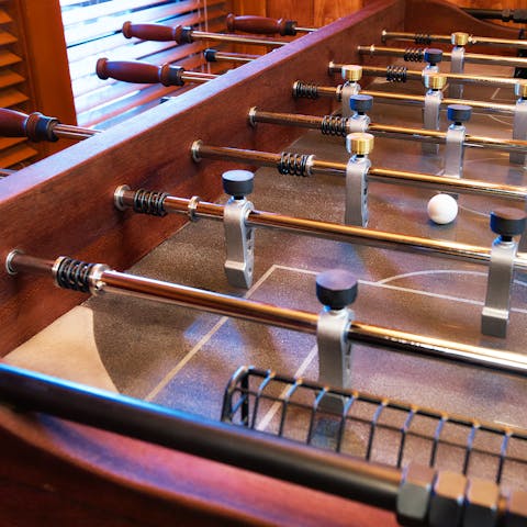 A designer foosball table made of bronze, steel, and walnut