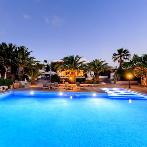 Dive into the blue waters of your pool for a refreshing dip under the stars