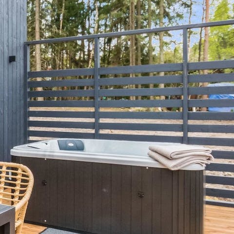 Relax and unwind in the outdoor hot tub 