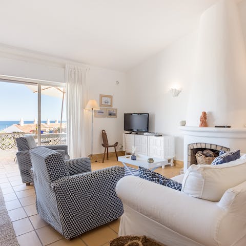 Sprawl out on the sumptuous white sofa in the living area after a long day exploring the Algarve