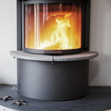 Stay warm in front of the glass-fronted wood burner