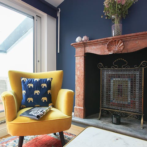 Catch up on your holiday reads in this cosy chair by the fireplace