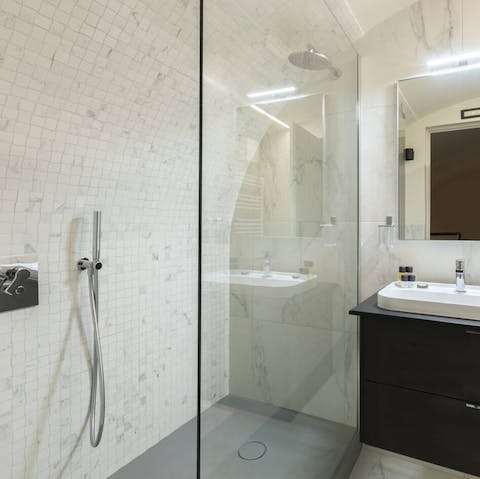 Feel anew in the marble-clad rainfall shower 