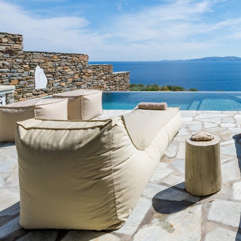 Appreciate the stunning seaside scenery on the lounge chairs 