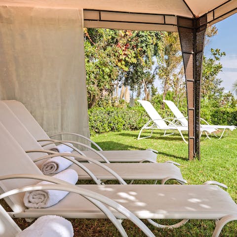 Enjoy some shade on a comfy sun lounger