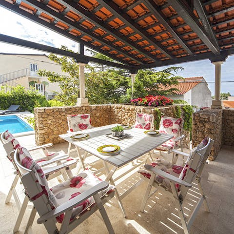 Enjoy a dinner alfresco out on your villa's stunning covered patio with views out to the harbour