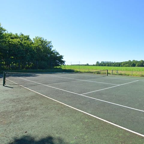 Challenge friends and family to a tennis match in your very own backyard