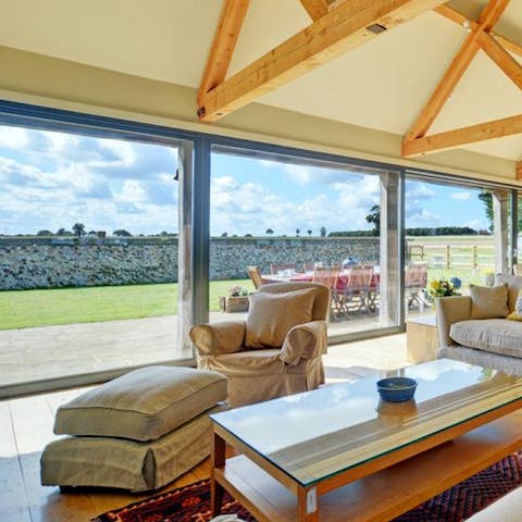 Relax in the living room where floor-to-ceiling windows let in floods of natural light