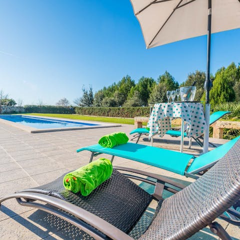 Relax on a sun lounger by the saltwater pool