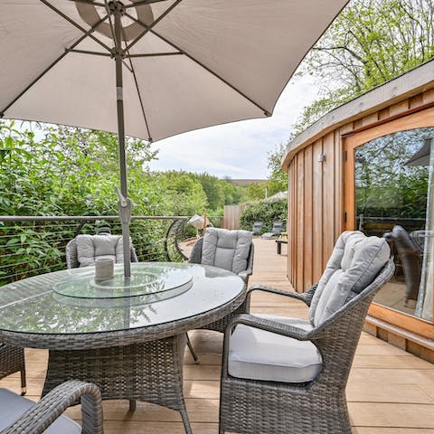 Dine al fresco surrounded by the lush trees