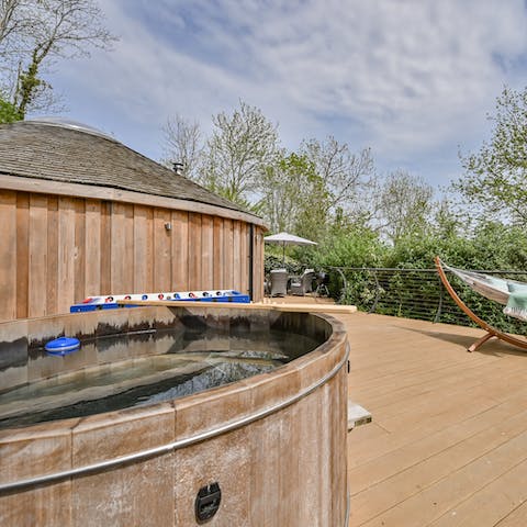 Unwind in the traditional wood-fired cedar hot tub