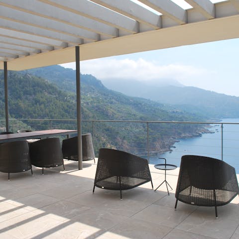 Dine al fresco on comfy lounge chairs under the shade of the veranda