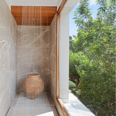 Soak under the rainfall shower while looking out to the surrounding greenery