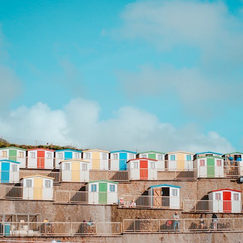 Admire Bude's colourful beach huts, only a 7 minute drive away