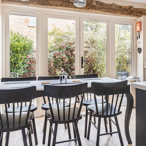 Dine together with a view of the garden just beyond the doors