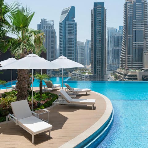 Spend leisurely afternoons lounging by the communal pool