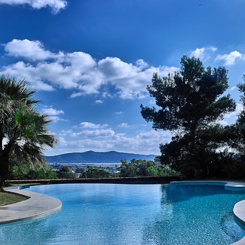 Enjoy dramatic mountain views from the dreamy freeform private pool