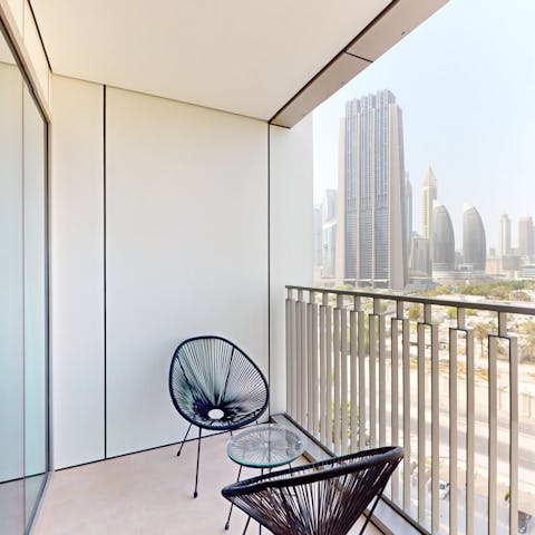 Sit on the balcony as you drink in the cityscape