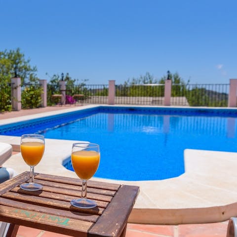Savour a fresh glass of orange juice by the pool