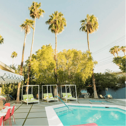 Lounge on citrus-coloured day beds by the communal pool