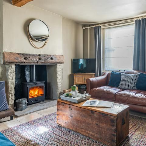 Get super cosy in the leather couch after lighting a fire in the wood-burning stove