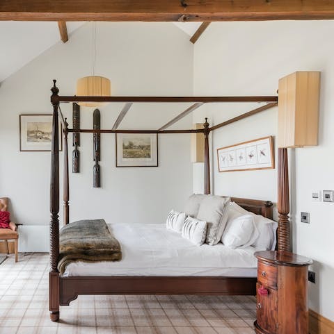 Sleep in a four-poster bed fit for a monarch