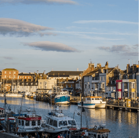 Enjoy fish and chips with a view at Weymouth Harbour, just a fifteen-minute drive away