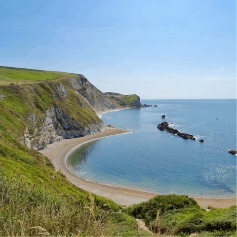 Discover towering cliffs and remarkable fossils along the surrounding Jurassic Coast