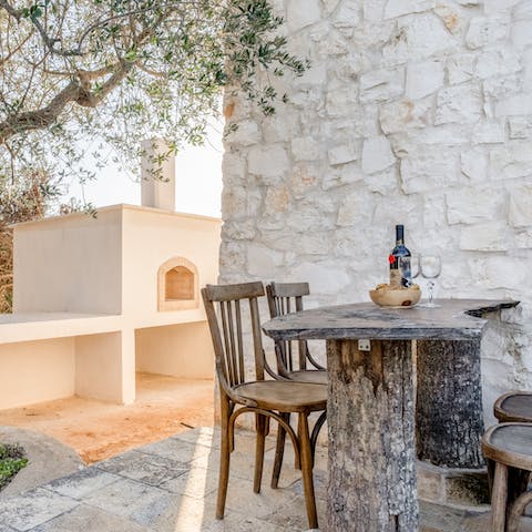 End each day with an alfresco aperitif under the olive tree