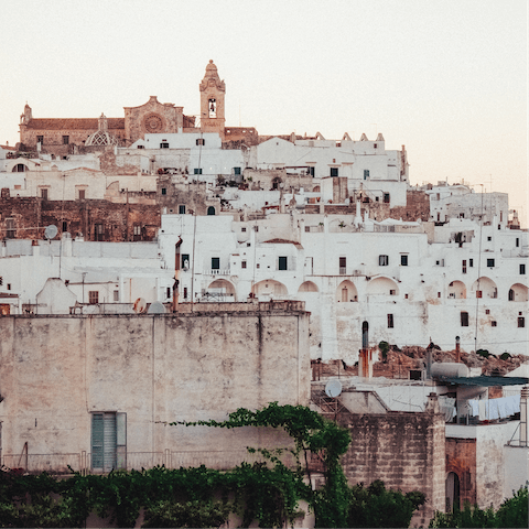 Wander through the whitewashed streets of Ostuni, just an eighteen-minute drive away