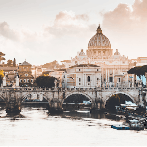 Catch the sunset over St Peter's Basilica from the Ponte Sant’Angelo—a five minute walk from your home 