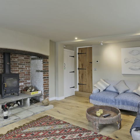 Cosy up by the log burner in the snug after a long coastal walk