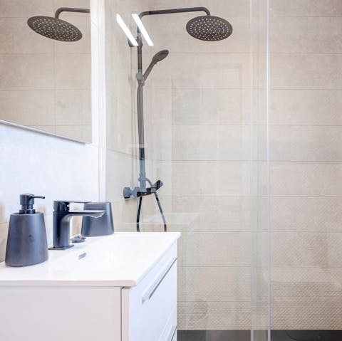 Star your day with a relaxing soak under the bathroom's rainfall shower