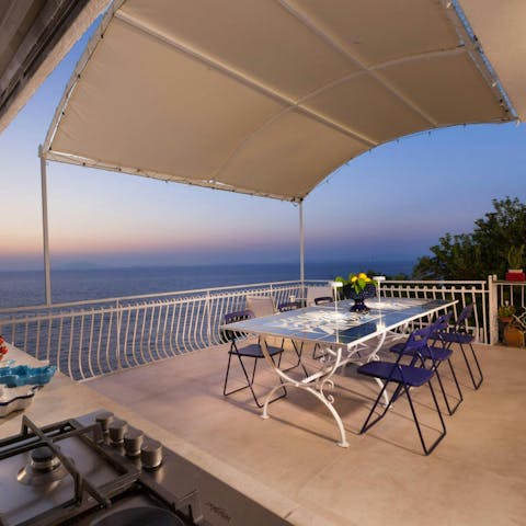 Enjoy an alfresco dinner on the private terrace as the sun sets over the sea