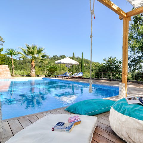 Hang out by the swimming pool on a warm afternoon