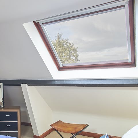 Stargaze through the skylight window on a clear night 