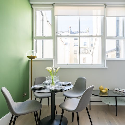 Dine in style next to the green feature wall and the sash windows