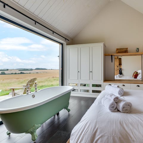 Unwind in the bath as you overlook the verdant countryside