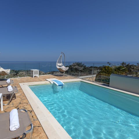 Swim in the private heated pool while gazing out at the Cretan Sea