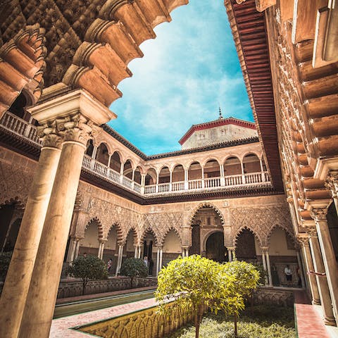 Stroll over to the Mudéjar-style Royal Alcázar of Seville in five minutes