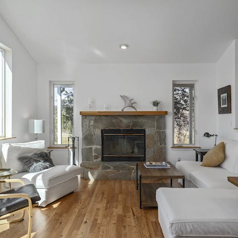 Gather in the main living space by the roaring fireplace for a cozy evening