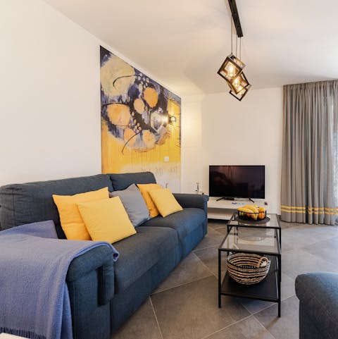 Admire the stylish touches and vibrant art in the living room