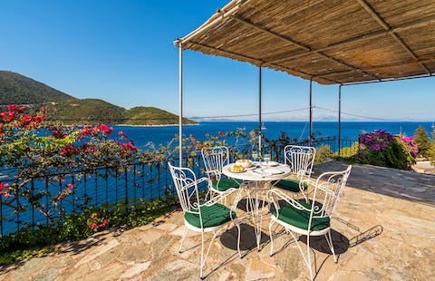 Enjoy an alfresco meal with views across the Ionian Sea to the mountains of northern Greece