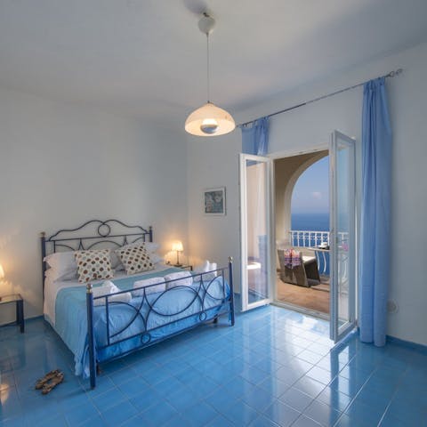 Retreat to your cool blue bedroom and watch a romantic sunset from this balcony